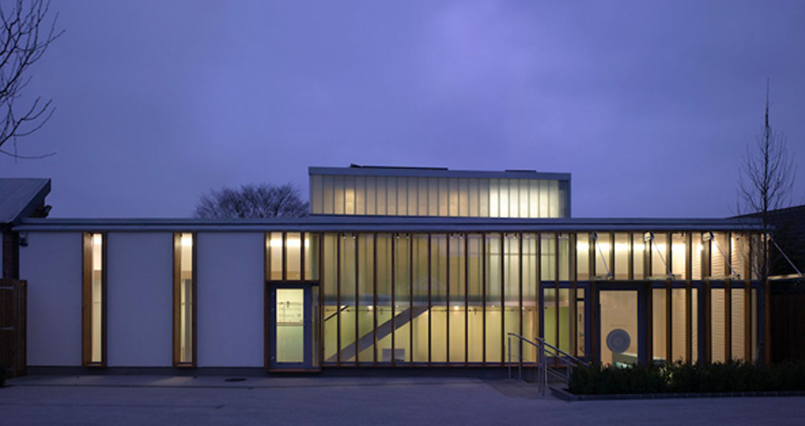 Exterior night time photograph of the advanced dental clinic building